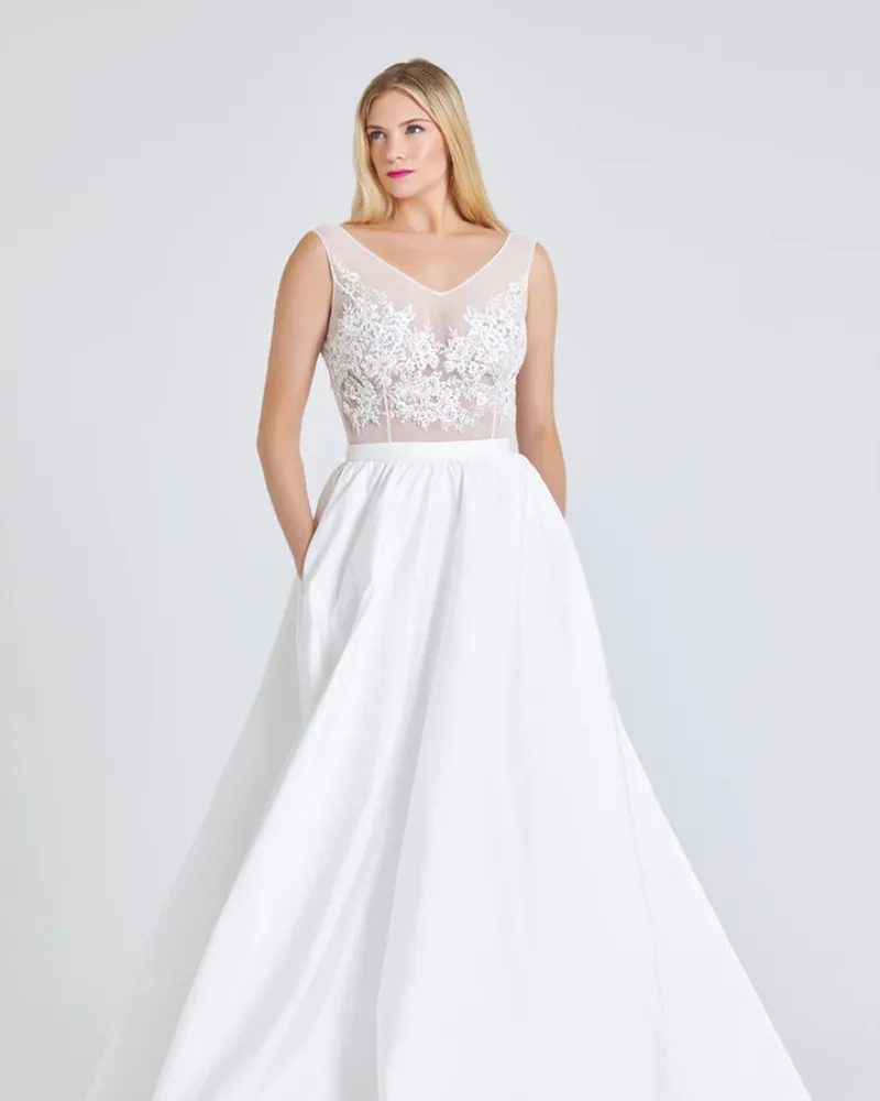 Ronke, front. Off-white tulle sleeveless bodice with V neckline and a full gathered ballgown skirt.