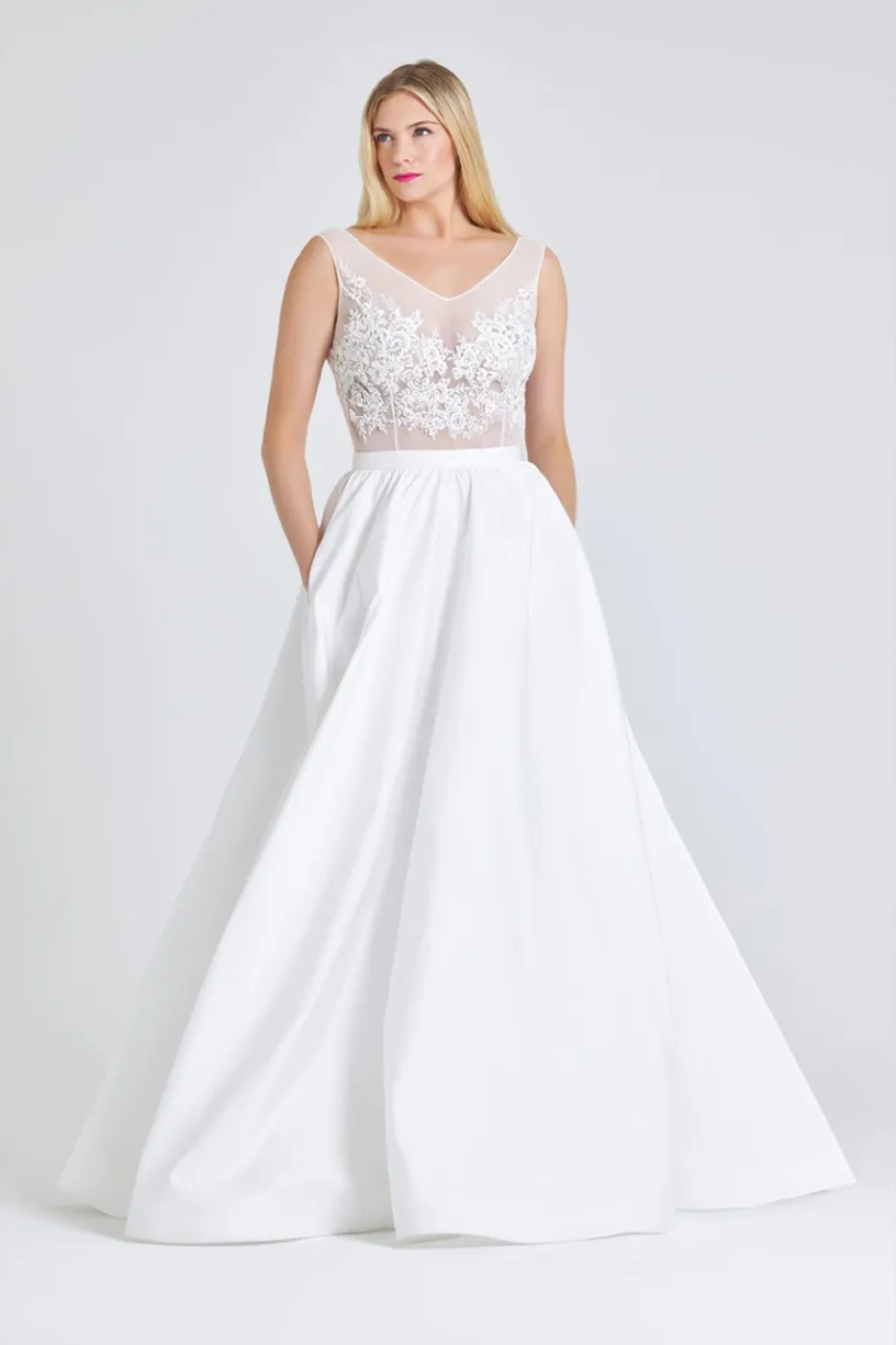Ronke, front. Off-white tulle sleeveless bodice with V neckline and a full gathered ballgown skirt.